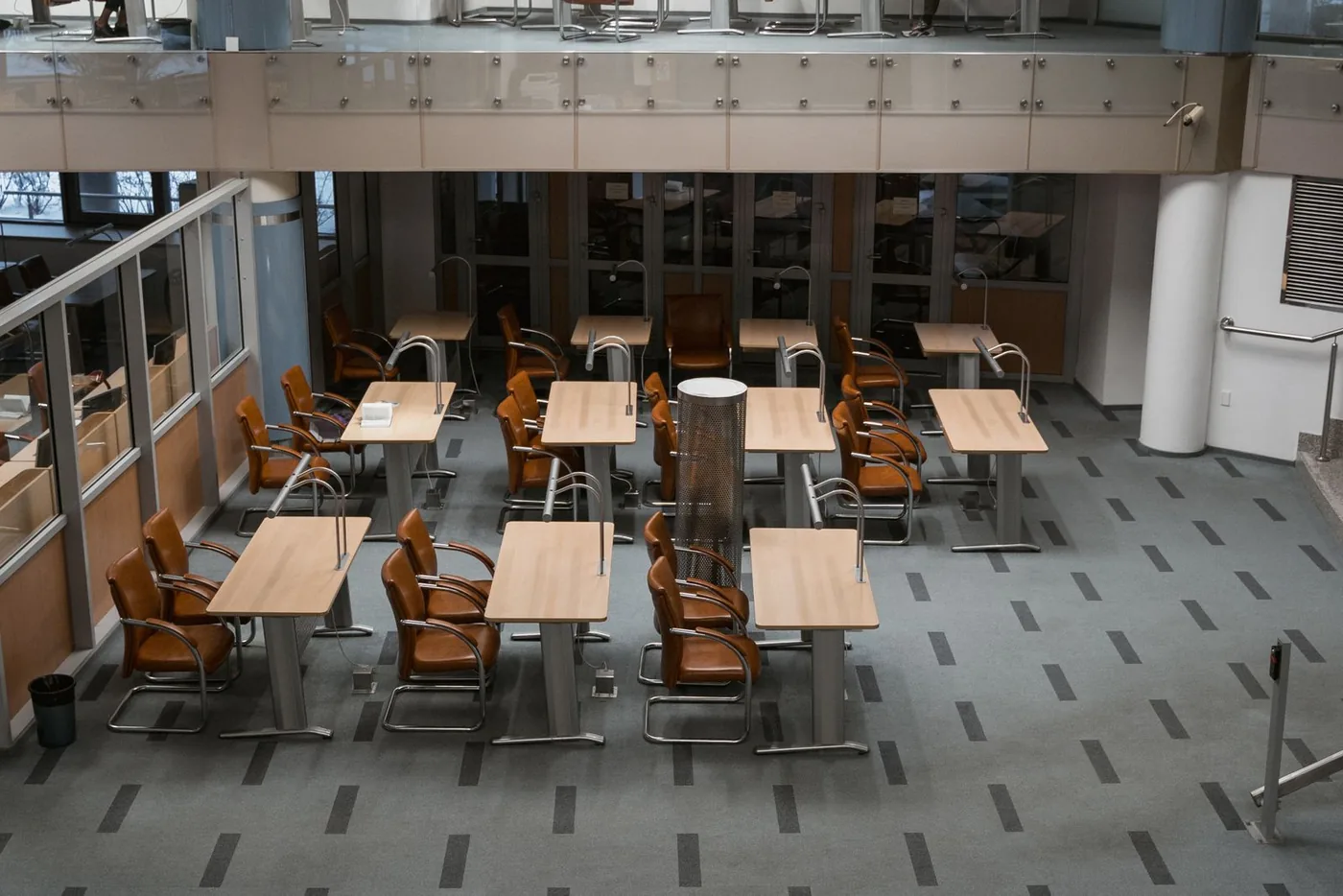 Bright, freshly cleaned modern office with tidy desks and chairs